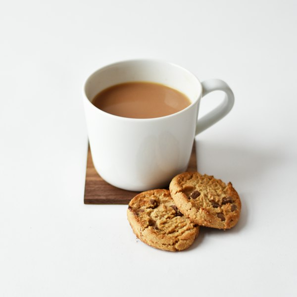 A cup of masala chai with cookies